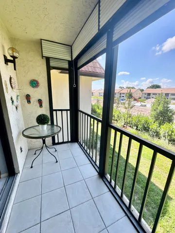 a view of a porch with furniture and garden
