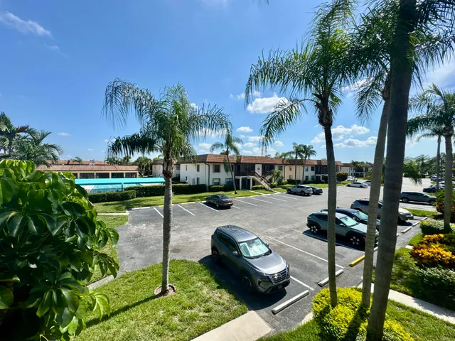 a swimming pool with outdoor seating and a garden