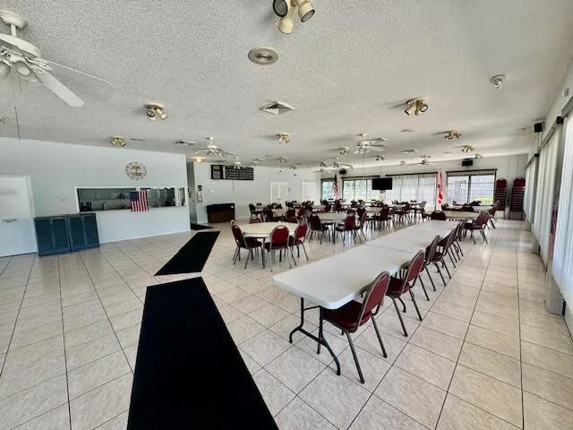 a living room with lots of furniture and kitchen view
