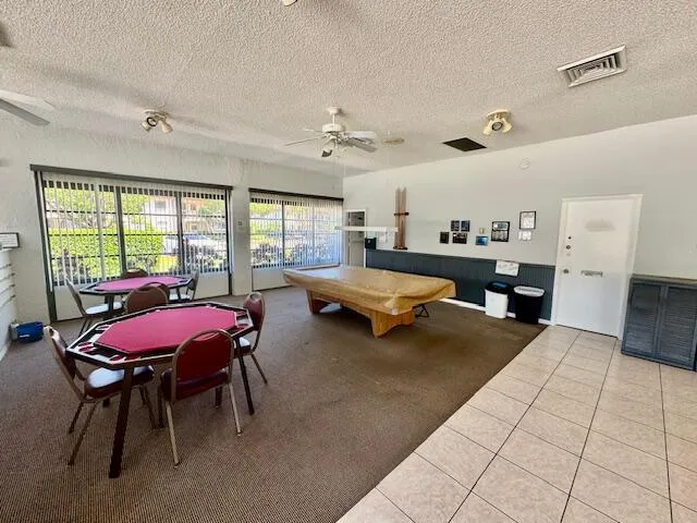 a living room with furniture a rug and a chandelier
