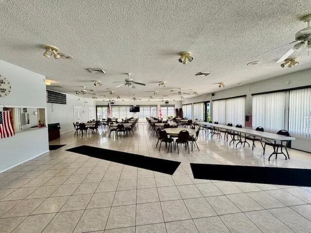 a view of a interior and living room with lots of table and chairs