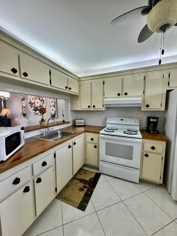 a kitchen with cabinets appliances and a sink