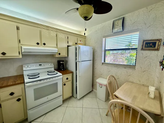 a kitchen with furniture a refrigerator and a sink
