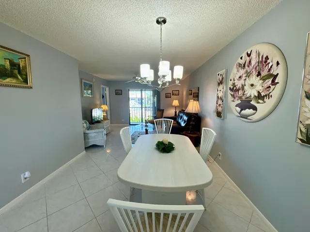 a view of a dining room with furniture and a chandelier