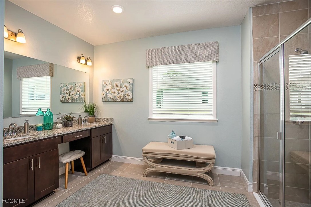 3023 North Lakewood Road LaBelle, FL 33935 - Photo 11 of 39 a spacious bathroom with double vanity and a mirror