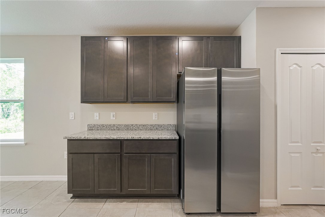 3023 North Lakewood Road LaBelle, FL 33935 - Photo 21 of 39 a metallic refrigerator freezer sitting in a kitchen