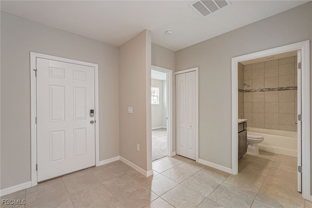 3023 North Lakewood Road LaBelle, FL 33935 - Photo 32 of 39 a view of a bathroom with toilet cabinet and window