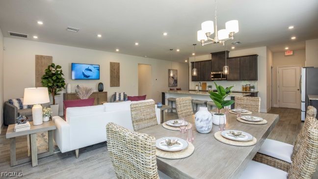 3023 North Lakewood Road LaBelle, FL 33935 - Photo 7 of 39 a view of a dining room with furniture and a chandelier