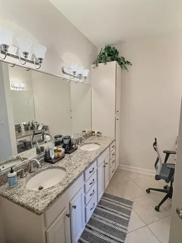 a bathroom with a sink double vanity and a mirror
