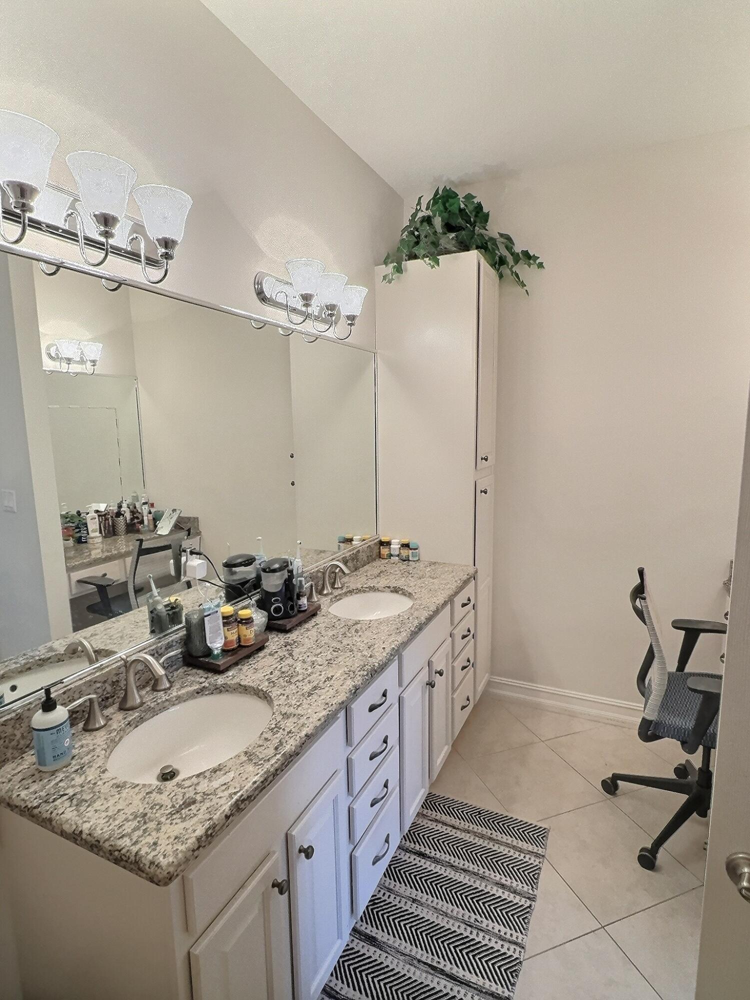 10320 Southwest Stephanie Way, Unit 7210 Port St. Lucie, FL 34987 - Photo 12 of 15 a bathroom with a sink double vanity and a mirror