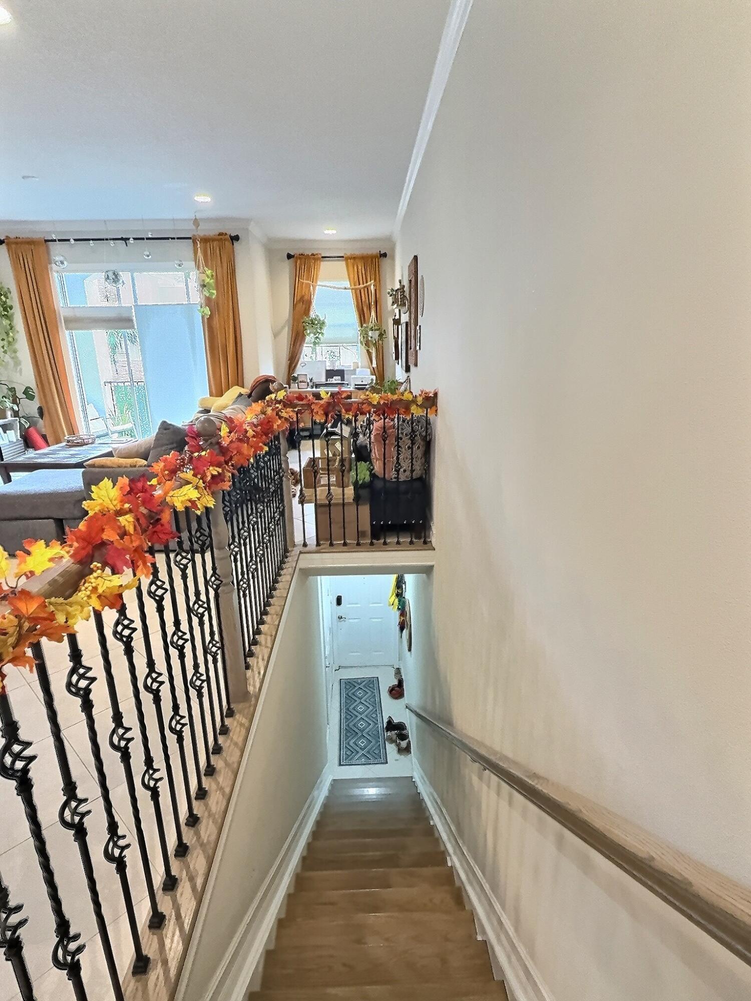 10320 Southwest Stephanie Way, Unit 7210 Port St. Lucie, FL 34987 - Photo 15 of 15 a view of a hallway with wooden floor and staircase