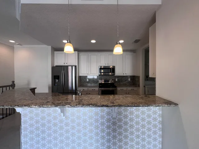 a view of a kitchen with a stove and a sink
