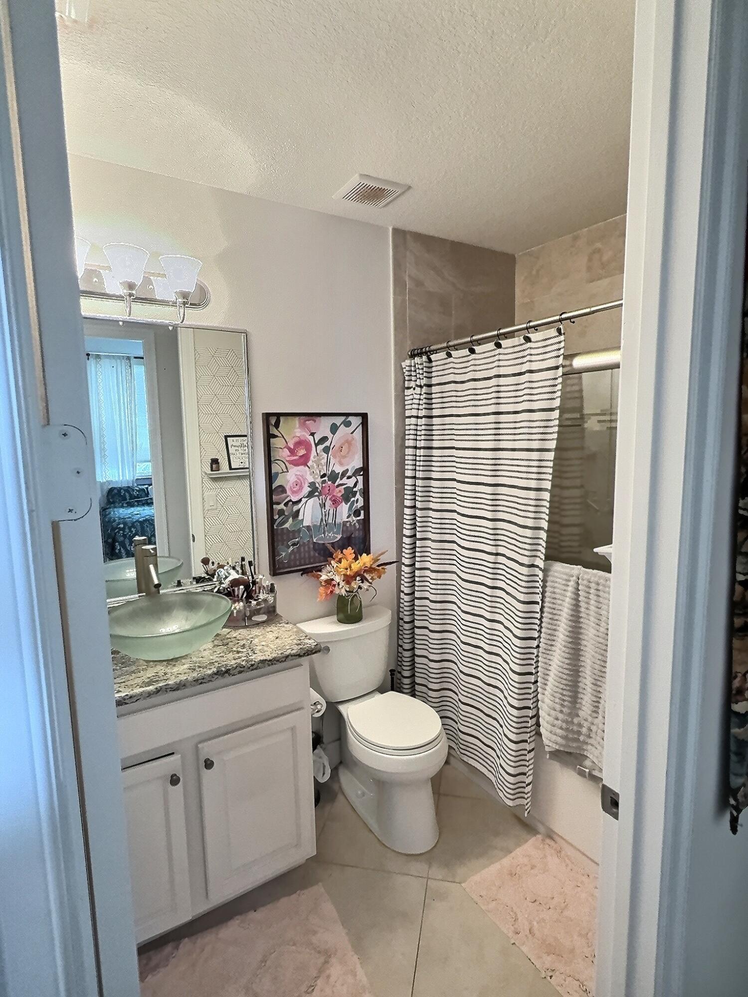 10320 Southwest Stephanie Way, Unit 7210 Port St. Lucie, FL 34987 - Photo 8 of 15 a bathroom with a sink toilet and shower