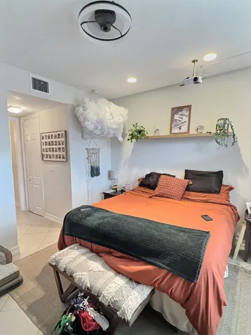 a bedroom with a bed and a chandelier