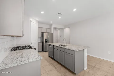a kitchen with a sink stove and refrigerator