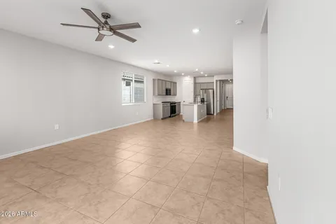 a view of a kitchen with furniture and ceiling fan