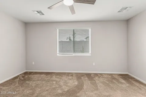 an empty room with a window and closet