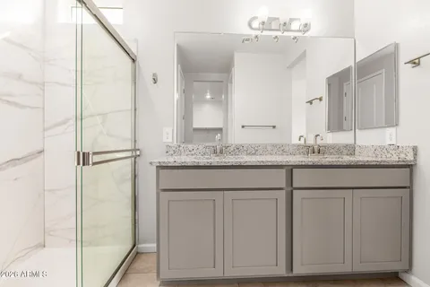 a bathroom with a granite countertop sink and a mirror