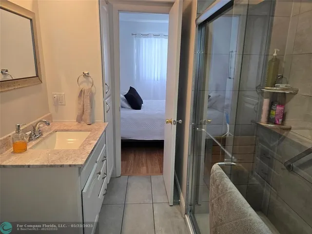 a bathroom with a granite countertop sink and a mirror