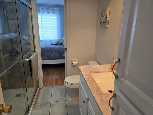 a bathroom with a toilet and a shower
