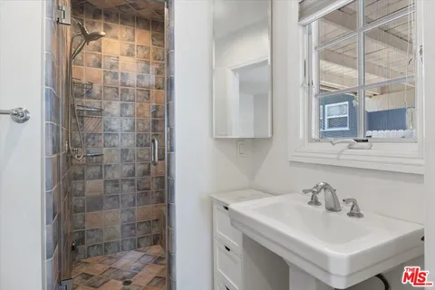 a bathroom with a sink toilet and shower
