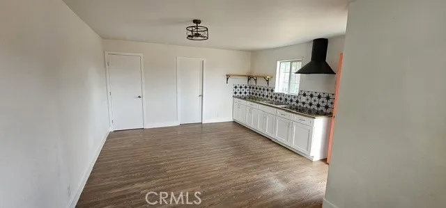 a kitchen with granite countertop a stove and a refrigerator