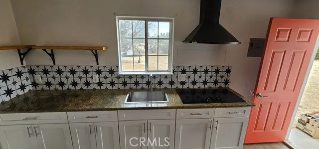 a kitchen with sink and cabinets