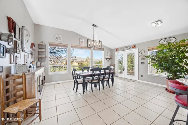 a view of a dining room and kitchen with furniture and a chandelier