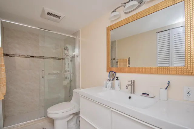 a bathroom with a sink toilet and shower