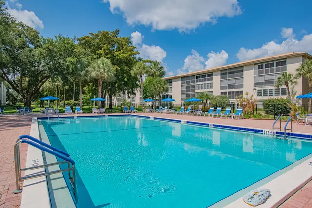a swimming pool view with a outdoor seating