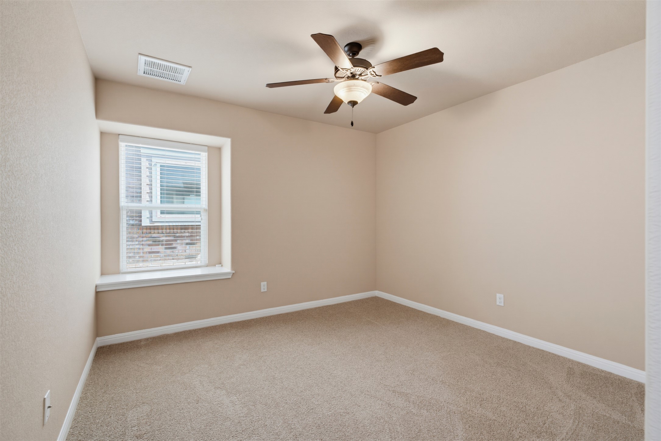 6033 Roma Street Round Rock, TX 78665 - Photo 21 of 28 Soft carpeting underfoot and a deep window sill define this versatile bedroom space.