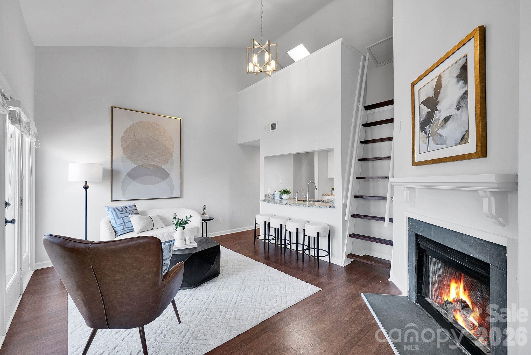 300 South Cedar Street, Unit 2 Charlotte, NC 28202 - Photo 5 of 29 a living room with furniture a fireplace and a wall painting