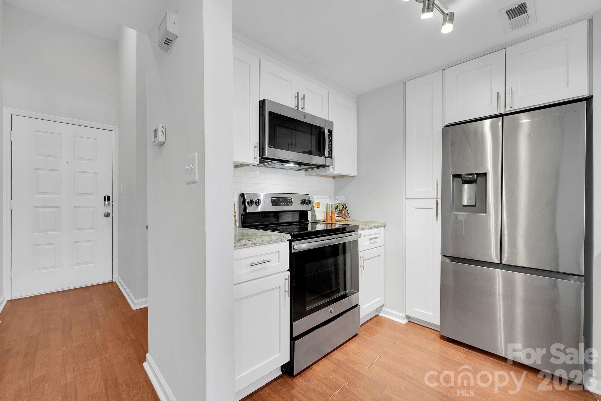 300 South Cedar Street, Unit 2 Charlotte, NC 28202 - Photo 7 of 29 a kitchen with a refrigerator stove and microwave