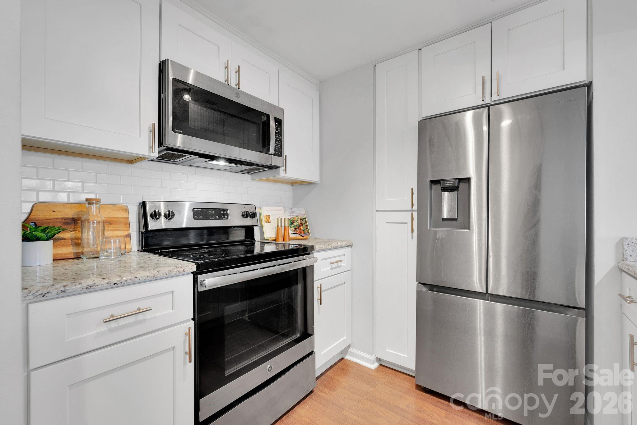 300 South Cedar Street, Unit 2 Charlotte, NC 28202 - Photo 8 of 29 a kitchen with stainless steel appliances a refrigerator microwave and sink