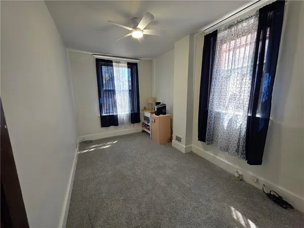 an empty room with windows and closet