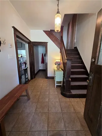 a view of entryway and hall with a front door