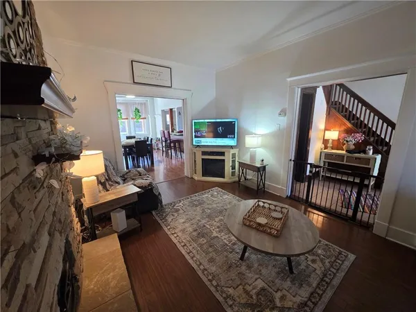 a living room with furniture a flat screen tv and a fireplace