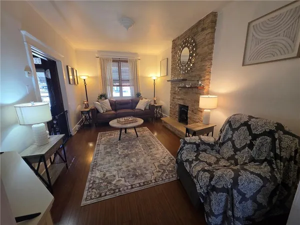 a living room with furniture and a fireplace