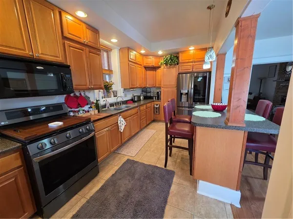 a kitchen with stainless steel appliances a stove a sink dishwasher and cabinets