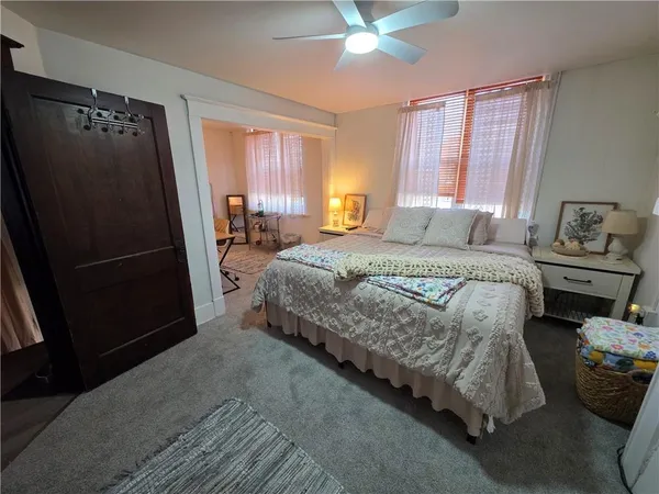 a bedroom with bed and window