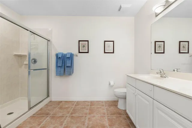 a bathroom with a shower and a glass door