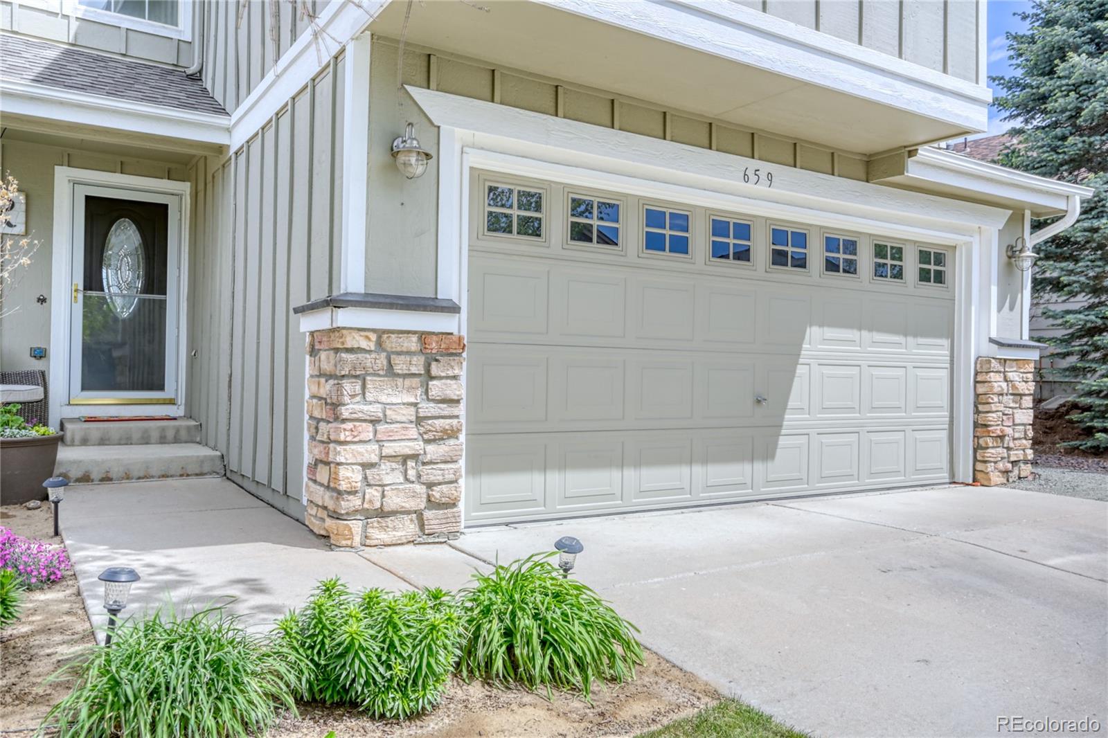 659 Timbervale Trail Highlands Ranch, CO 80129 - Photo 2 of 32 a front view of a house with a garden
