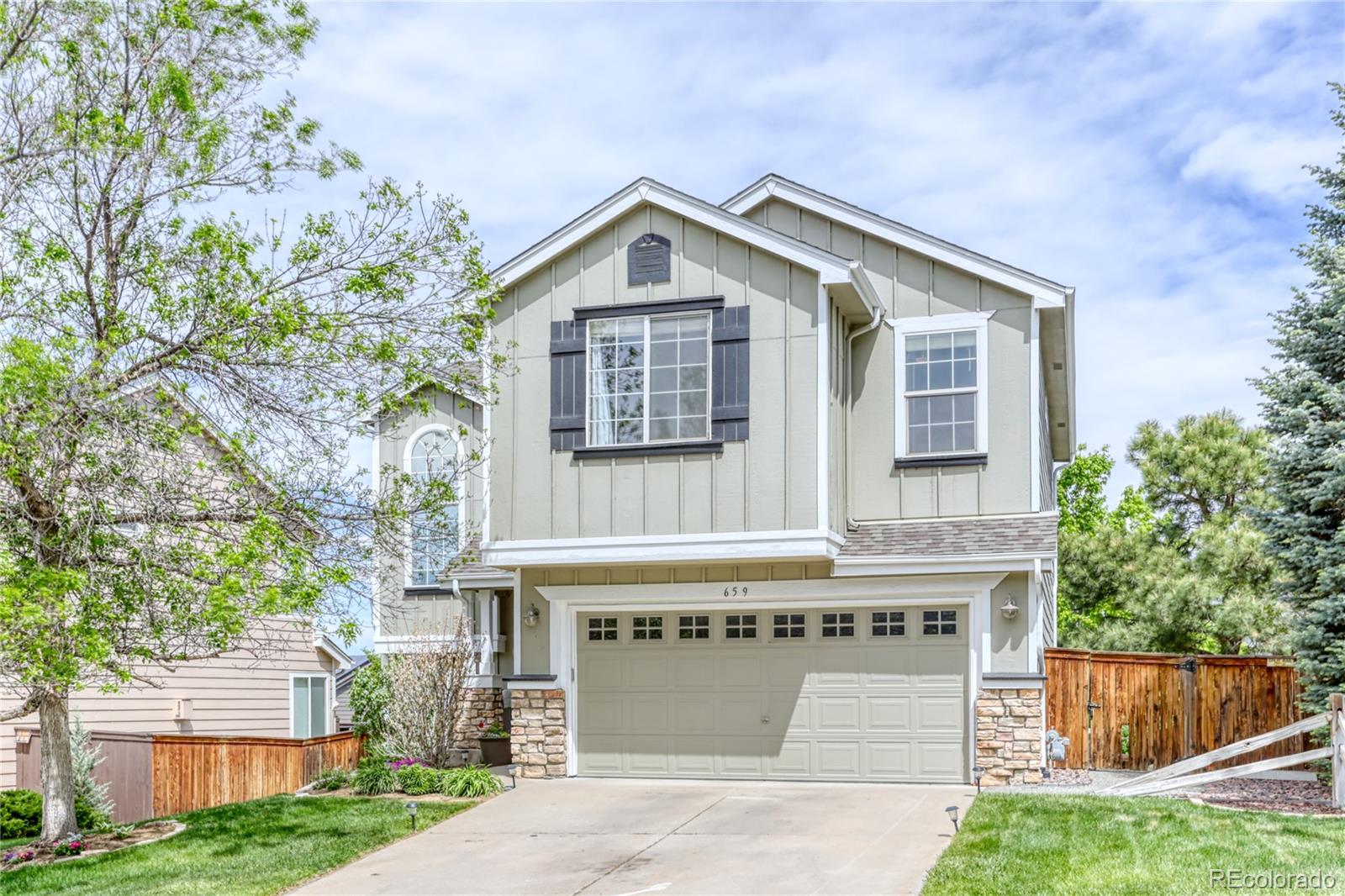 659 Timbervale Trail Highlands Ranch, CO 80129 - Photo 32 of 32 a view of house with yard and outdoor seating