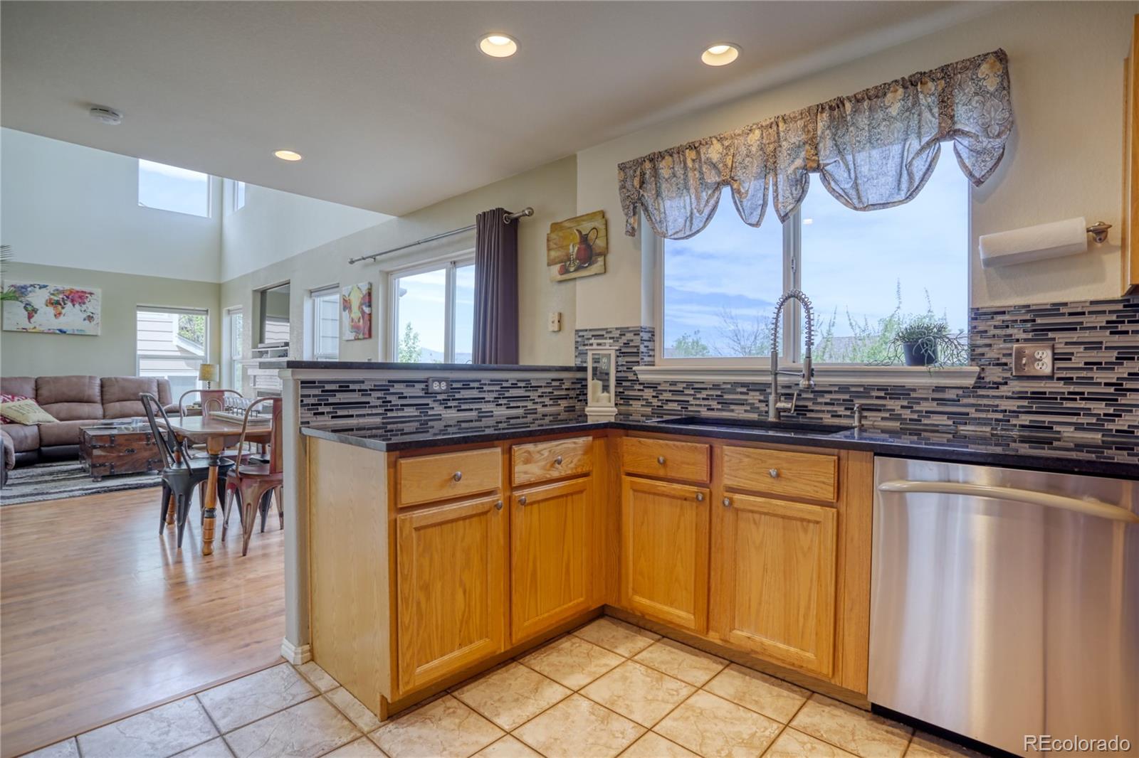 659 Timbervale Trail Highlands Ranch, CO 80129 - Photo 8 of 32 a kitchen with granite countertop a sink and cabinets