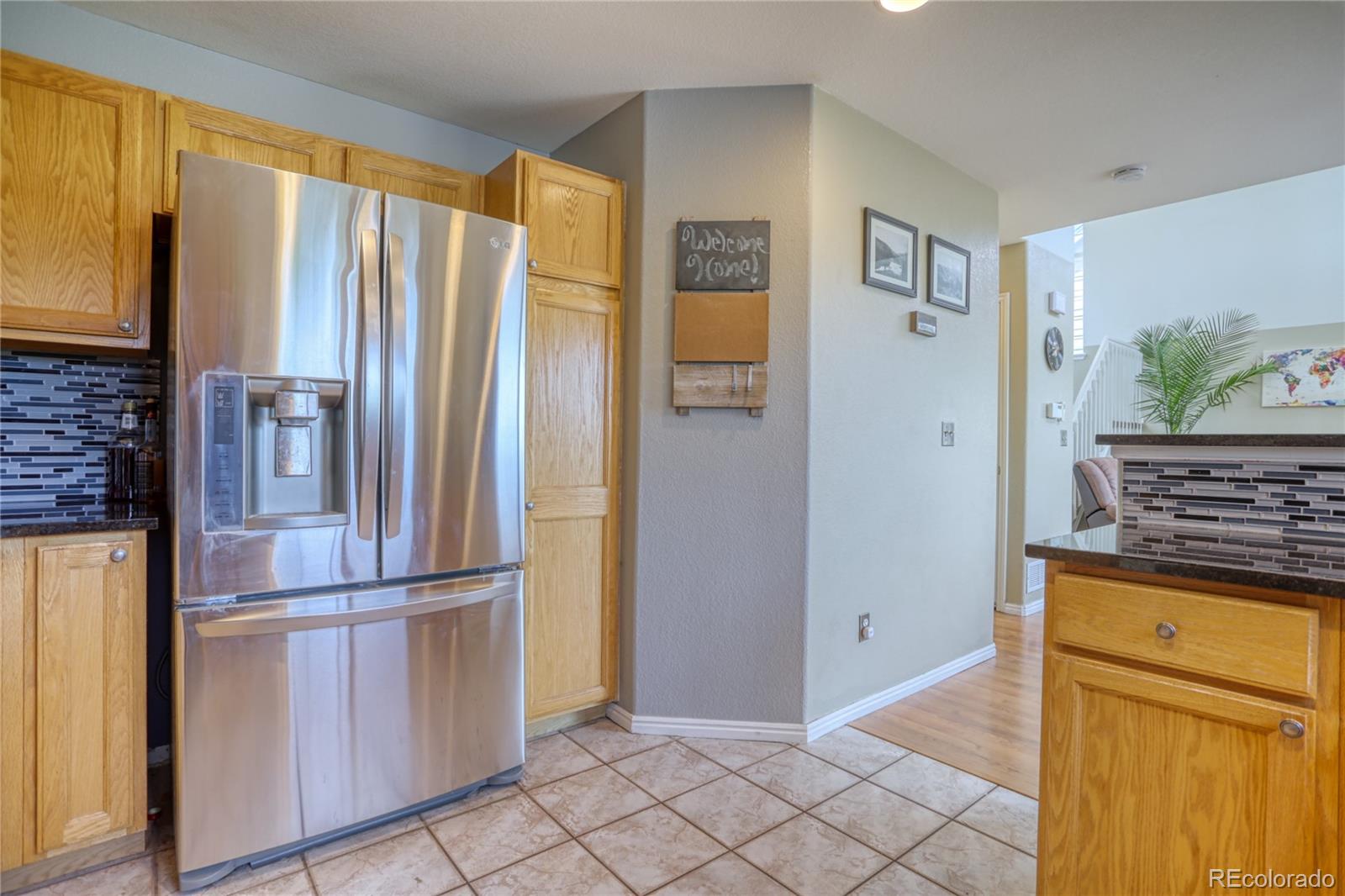 659 Timbervale Trail Highlands Ranch, CO 80129 - Photo 9 of 32 a kitchen with stainless steel appliances granite countertop a refrigerator and a stove