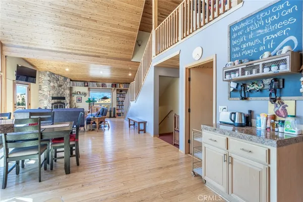 a kitchen with stainless steel appliances refrigerator dining table and chairs