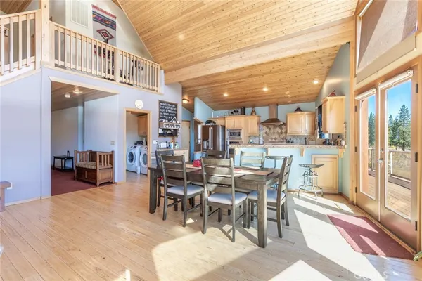 a dining area with furniture and a floor to ceiling window
