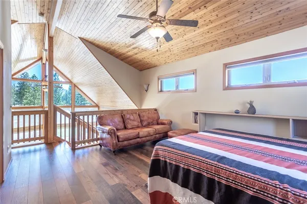 a bedroom with furniture and wooden floor