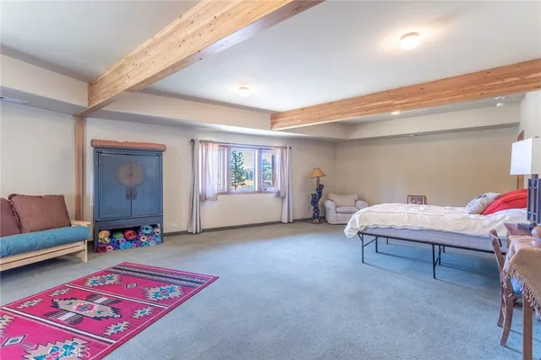 a spacious bedroom with a bed and window