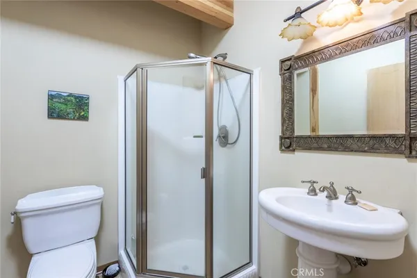 a bathroom with a sink toilet and mirror